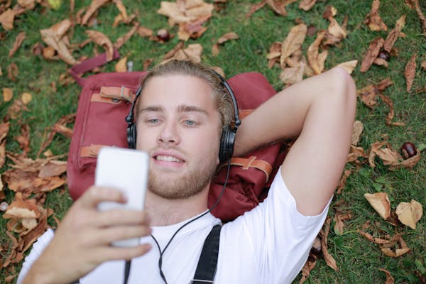 A man listening to music in a park